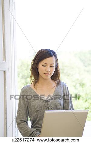 Picture - Woman using her laptop. Fotosearch