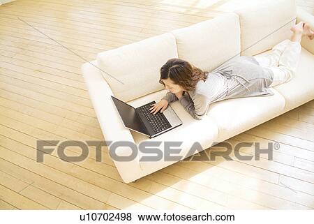 Stock Photo - Woman using her laptop. Fotosearch