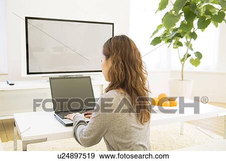 Woman using her laptop View Large Photo Image Stock Photo - Woman using her laptop. Fotosearch