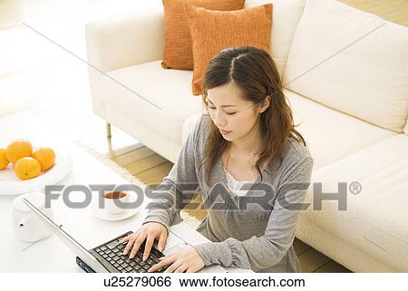 Stock Photograph - Woman using her laptop. Fotosearch