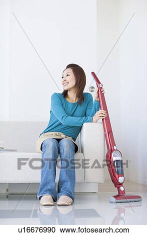 Woman vacuuming house View Large Photo Image Stock Image - Woman vacuuming house. Fotosearch
