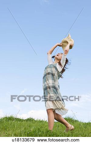 Stock Photo - Woman with a straw hat. Fotosearch