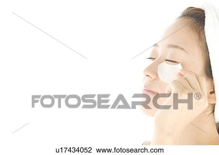 Stock Image - Woman with de-bag eye patches. Fotosearch