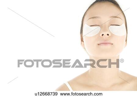 Woman with de-bag eye patches View Large Photo Image Stock Photo - Woman with de-bag eye patches. Fotosearch