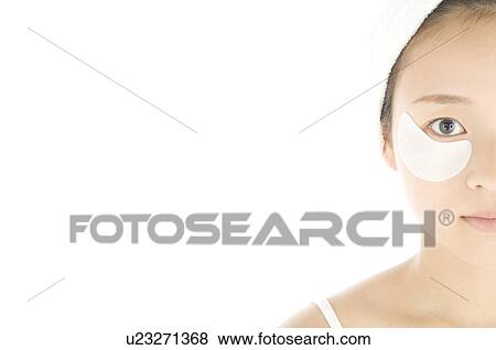 Stock Photo - Woman with de-bag eye patches. Fotosearch