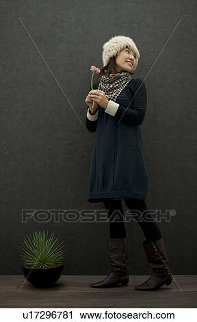 Woman with potted plant View Large Photo Image Stock Image - Woman with potted plant. Fotosearch