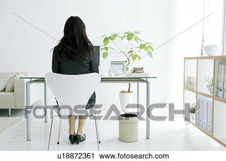 Stock Image - Woman working from home. Fotosearch