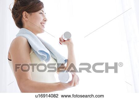 Woman working out at dumbbells View Large Photo Image Stock Image - Woman working out at dumbbells. Fotosearch