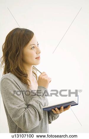 Woman writing in her diary View Large Photo Image Stock Image - Woman writing in her diary. Fotosearch