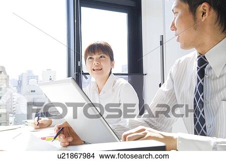 Picture - Workers in a business meeting. Fotosearch