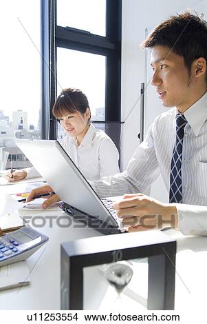 Workers in a business meeting with an hourglass View Large Photo Image Picture - Workers in a business meeting with an hourglass. Fotosearch