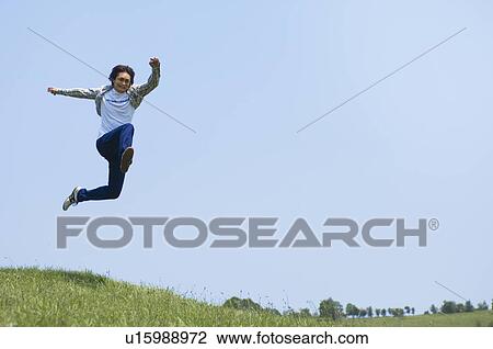 Young man jumping View Large Photo Image Stock Image - Young man jumping. Fotosearch