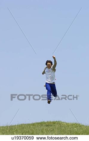 Stock Photo - Young man jumping. Fotosearch
