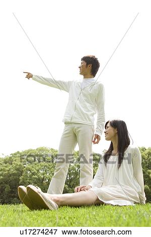 Young man pointing something out to his girlfriend View Large Photo Image Stock Photo - Young man pointing something out to his girlfriend. Fotosearch