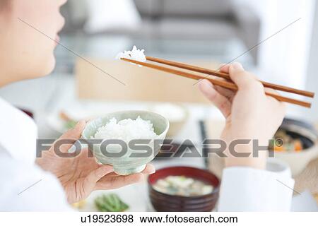 Young woman having a meal View Large Photo Image Stock Photo - Young woman having a meal. Fotosearch