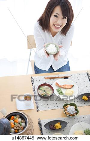 Young woman having a meal View Large Photo Image Stock Photography - Young woman having a meal. Fotosearch