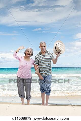 Stock Photo - Couple walking hand in hand. Fotosearch