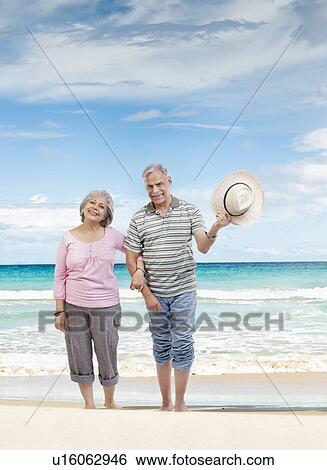 Stock Photograph - Couple walking hand in hand. Fotosearch