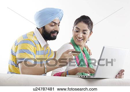 Couple with a laptop and credit card View Large Photo Image Stock Image - Couple with a laptop and credit card. Fotosearch