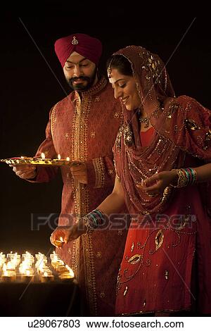 Couple with diyas View Large Photo Image Stock Image - Couple with diyas. Fotosearch
