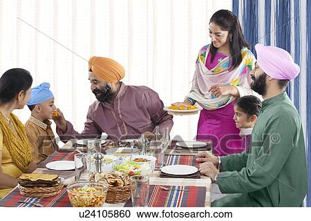 Stock Image - Grandfather feeding his grandson. Fotosearch