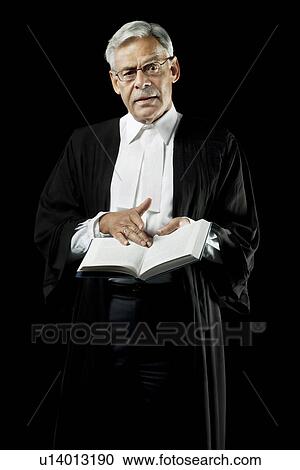 Stock Image - Lawyer holding a law book. Fotosearch