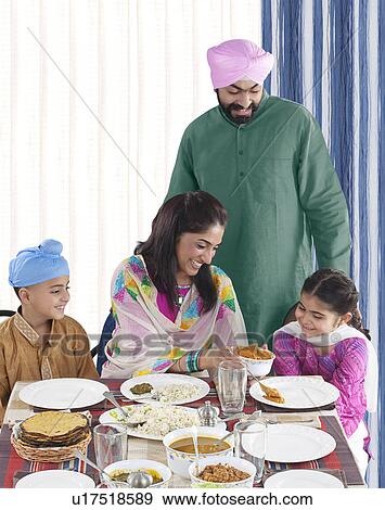 Stock Photo - Mother serving her daughter some food. Fotosearch