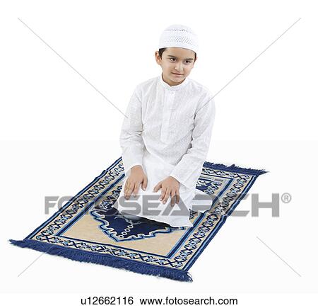 Stock Photograph - Muslim boy praying. Fotosearch