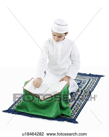 Muslim boy reading the Quran View Large Photo Image Stock Image - Muslim boy reading the Quran. Fotosearch