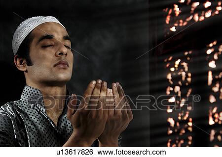 Stock Photograph - Muslim man praying. Fotosearch