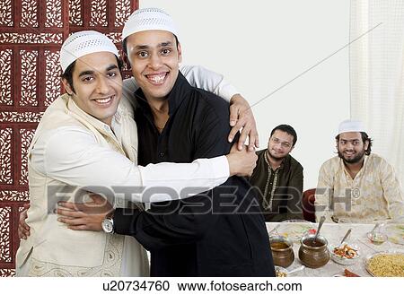 Muslim men hugging each other View Large Photo Image Stock Image - Muslim men hugging each other. Fotosearch