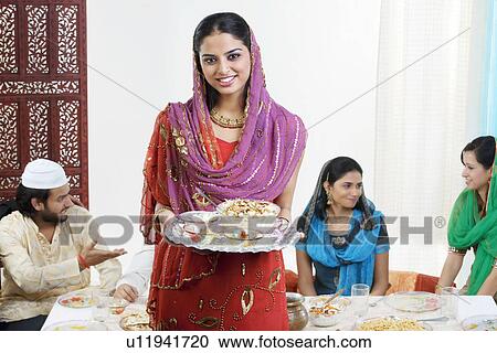 Muslim woman holding a tray with food View Large Photo Image Stock Image - Muslim woman holding a tray with food. Fotosearch
