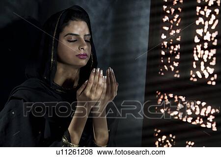 Muslim woman praying View Large Photo Image Stock Photo - Muslim woman praying. Fotosearch