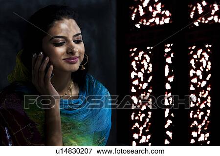 Stock Photo - Muslim woman talking on the phone. Fotosearch