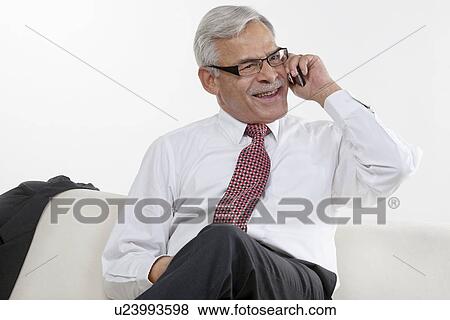 Stock Photo - Old businessman taking on the phone. Fotosearch