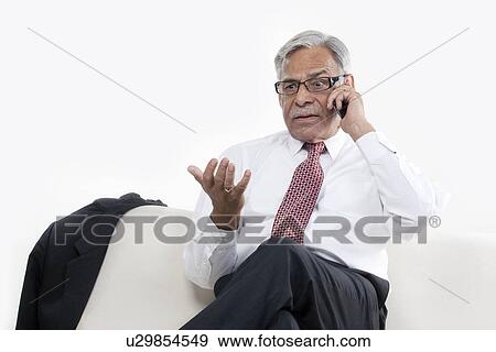 Old businessman taking on the phone View Large Photo Image Stock Photo - Old businessman taking on the phone. Fotosearch