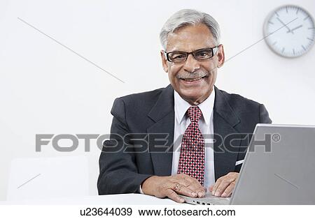 Old businessman with a laptop View Large Photo Image Stock Photo - Old businessman with a laptop. Fotosearch