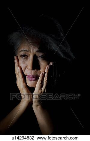 Stock Image - Old woman feeling depressed. Fotosearch