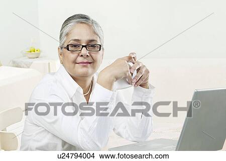 Old woman with a laptop View Large Photo Image Picture - Old woman with a laptop. Fotosearch