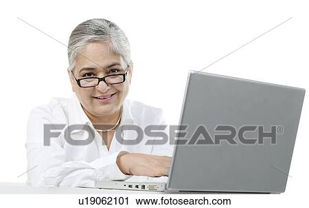 Stock Image - Old woman with a laptop. Fotosearch