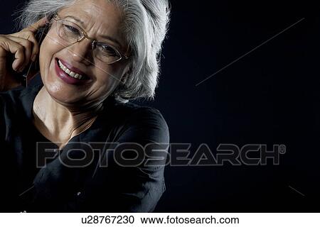 Stock Image - Old woman with glasses smiling. Fotosearch
