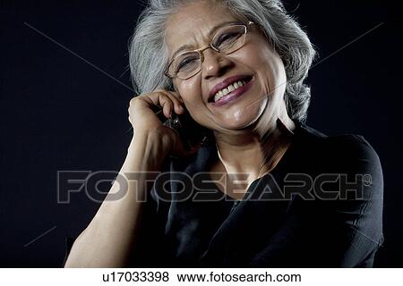 Stock Photo - Old woman with glasses smiling. Fotosearch