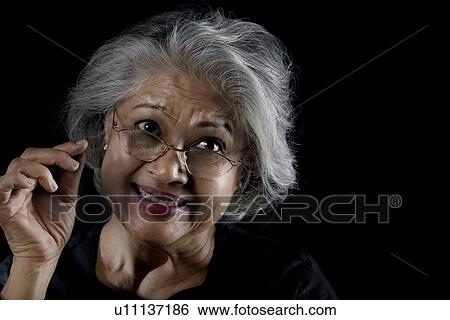 Stock Photograph - Old woman with glasses smiling. Fotosearch
