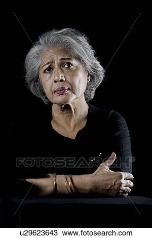Stock Image - Old woman worried. Fotosearch