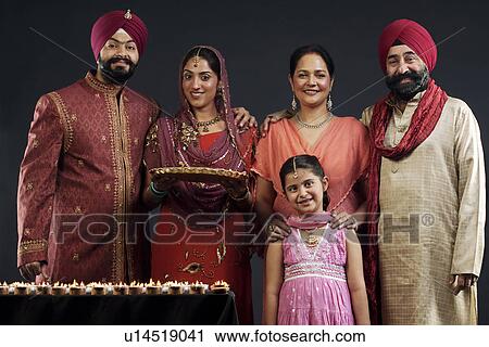 Stock Image - Portrait of a Sikh family with diyas. Fotosearch
