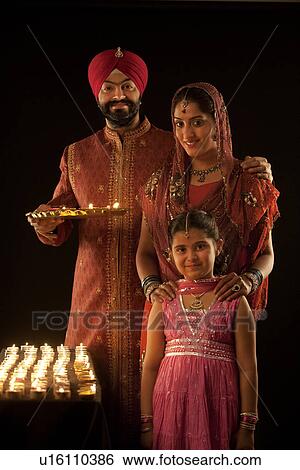 Stock Photograph - Portrait of a Sikh family with diyas. Fotosearch