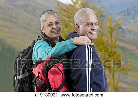 Stock Image - Portrait of old couple with hiking gear. Fotosearch