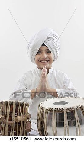 Stock Image - Sikh boy with a tabla. Fotosearch