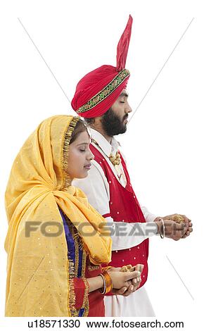 Stock Image - Sikh couple praying. Fotosearch