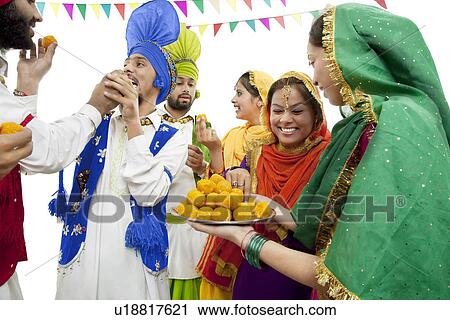 Sikh people eating laddoos View Large Photo Image Stock Image - Sikh people eating laddoos. Fotosearch